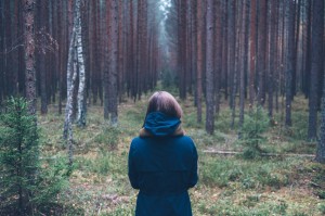 woman standing in forest to show healthy lifestyle